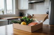 Realistic angled photo of a meal kit box with lid open on a kitchen counter