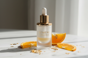 Lumière Glow Serum hero shot on marble with gold leaf and orange slices